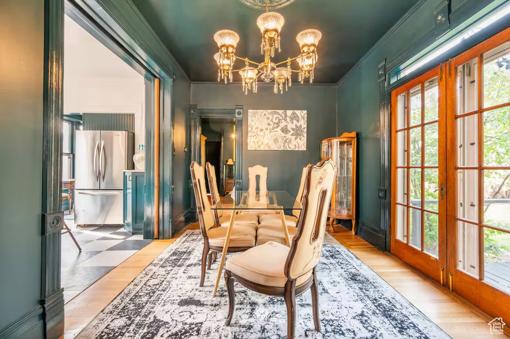 Dining space featuring ornamental molding and hardwood / wood-style flooring