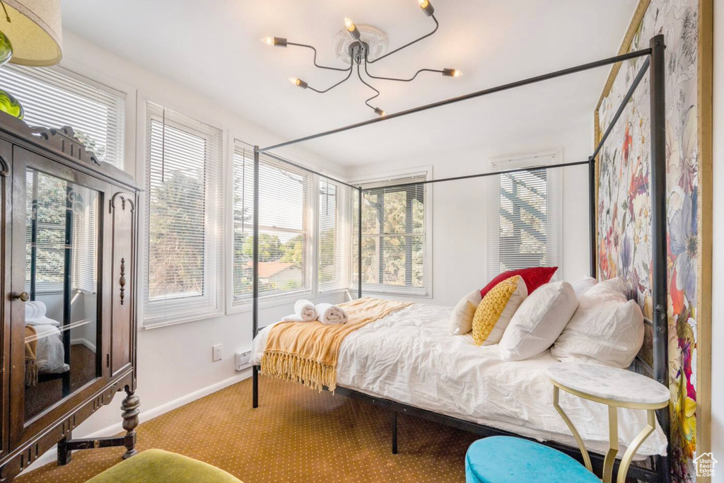 Carpeted bedroom featuring multiple windows