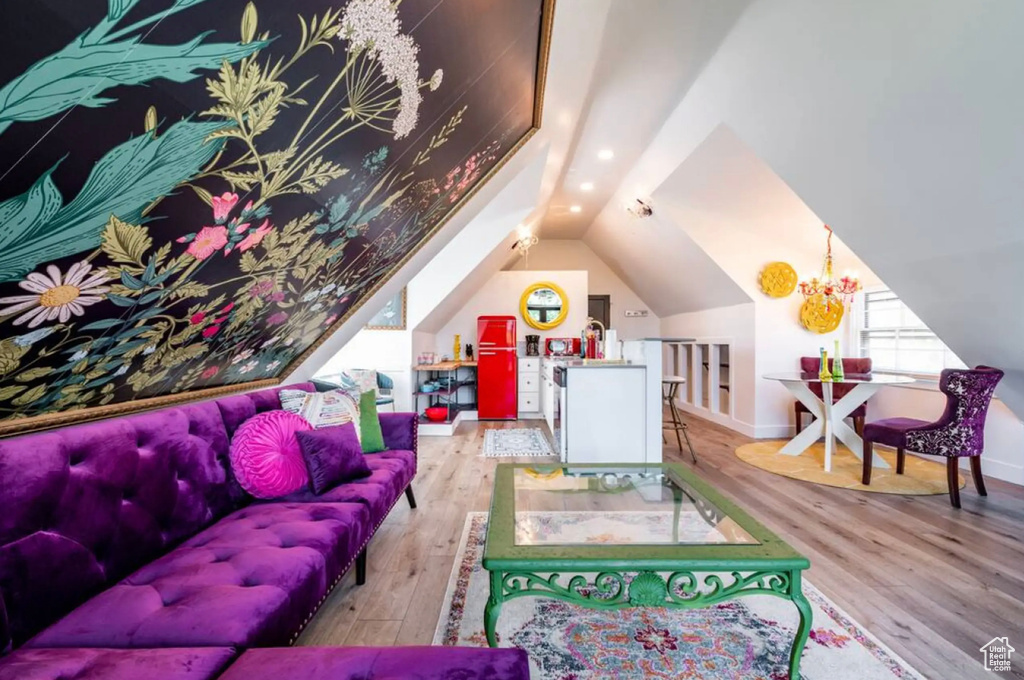 Recreation room featuring lofted ceiling, a chandelier, and light hardwood / wood-style flooring