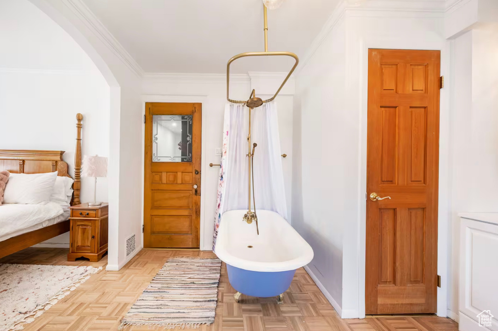 Foyer entrance with crown molding and light parquet flooring