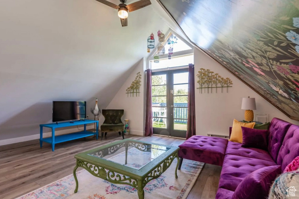 Living room with french doors, a baseboard heating unit, wood-type flooring, vaulted ceiling, and ceiling fan