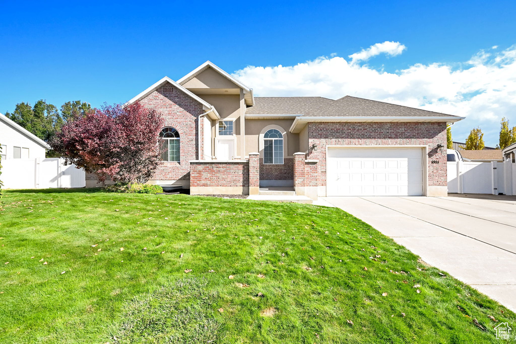 View of front facade with a front yard and a garage