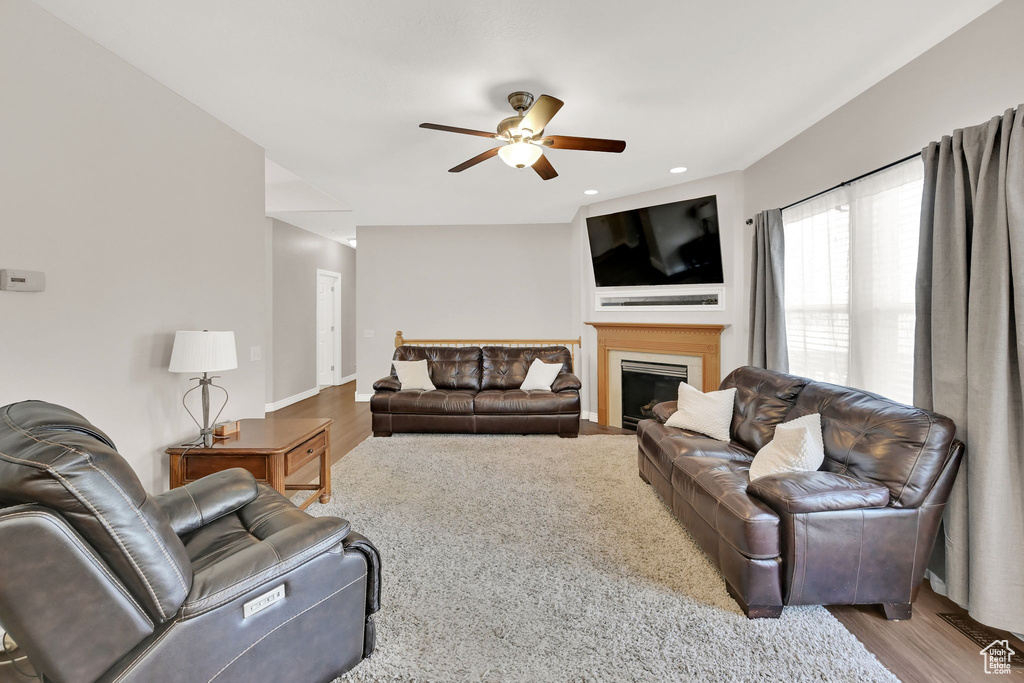 Living room with light hardwood / wood-style flooring and ceiling fan