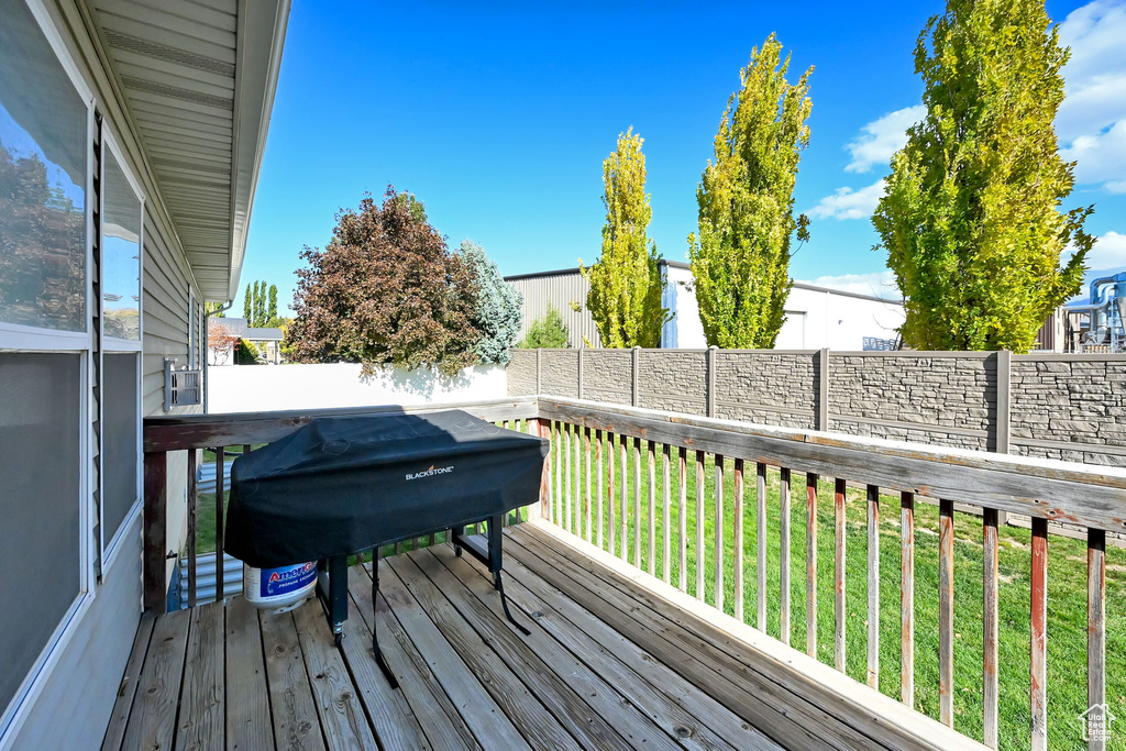 Wooden terrace with a yard and a grill