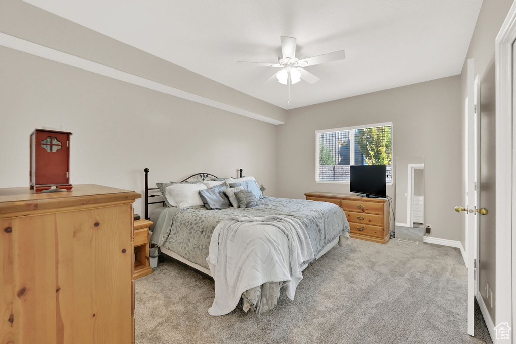 Carpeted bedroom featuring ceiling fan