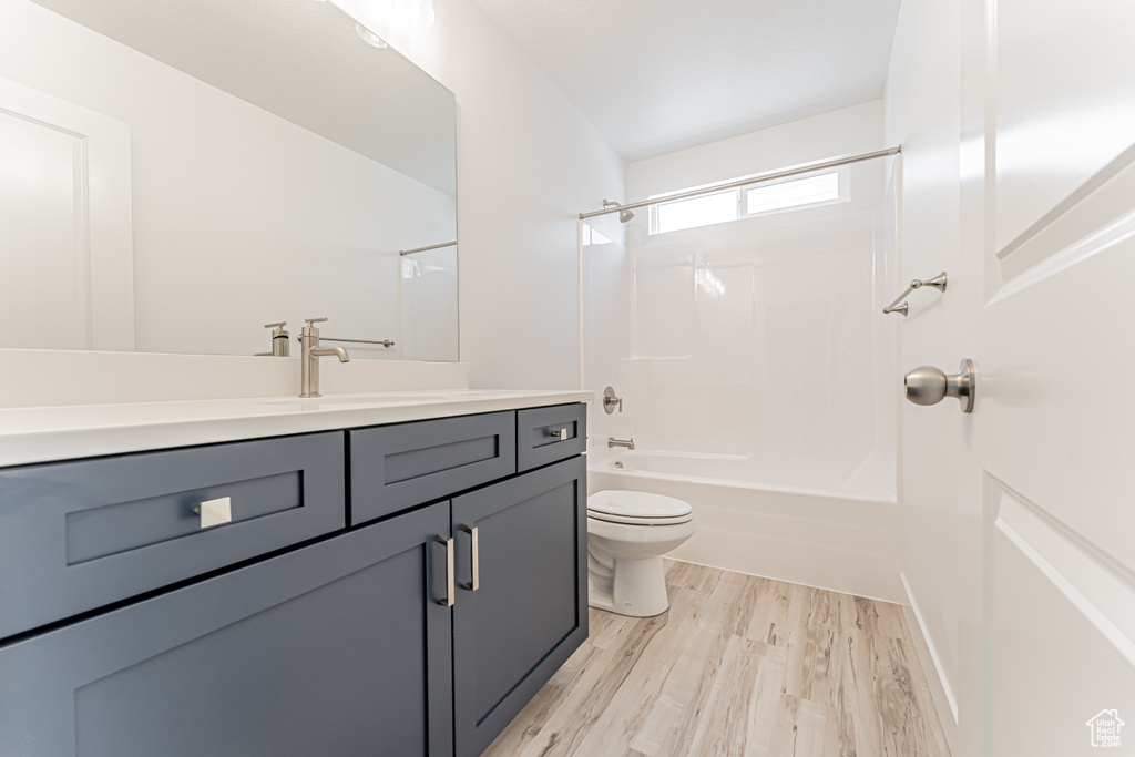 Full bathroom featuring vanity, wood finished floors, and bathtub / shower combination