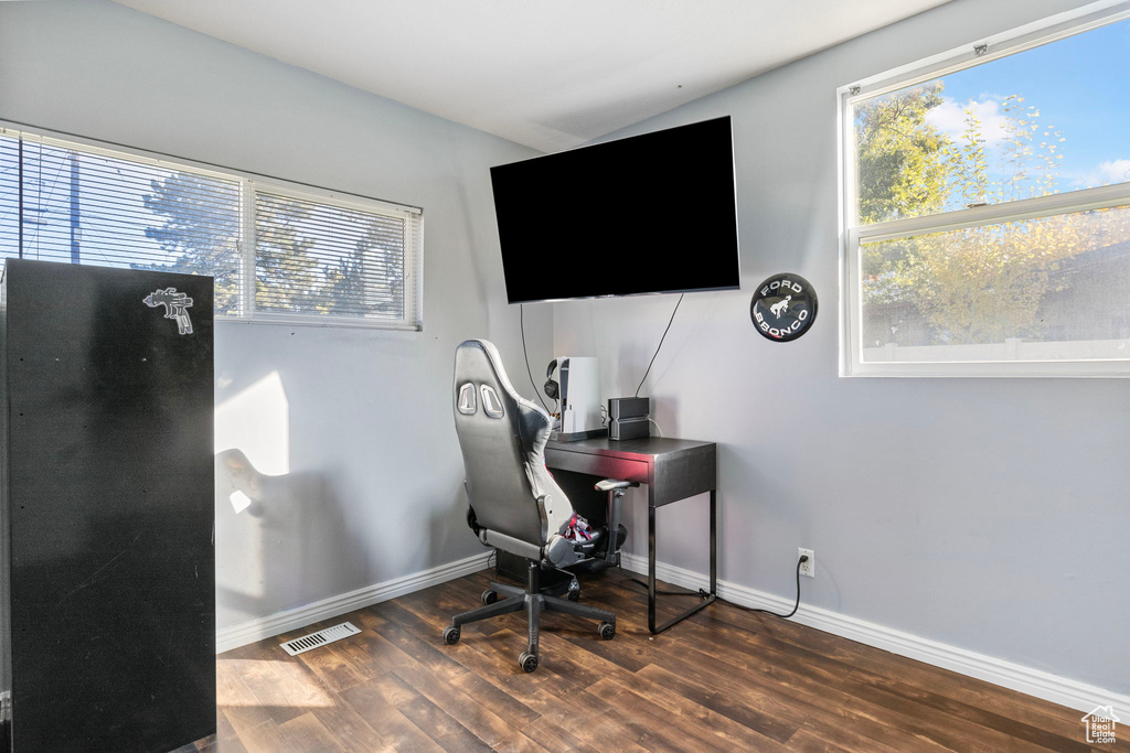 Home office with dark wood-type flooring