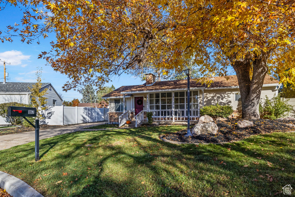 Single story home featuring a front lawn