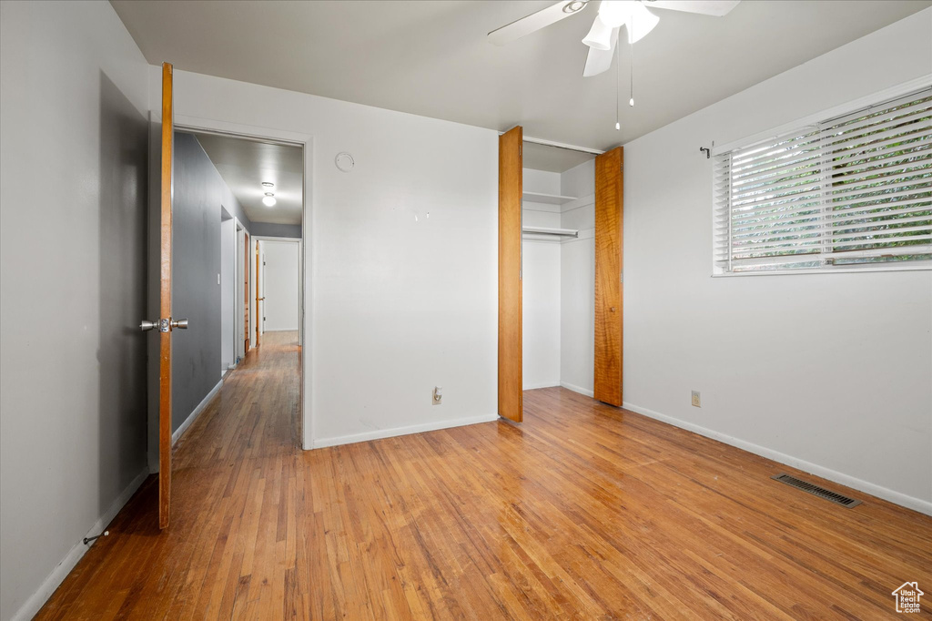 Unfurnished bedroom with light hardwood / wood-style flooring, a closet, and ceiling fan