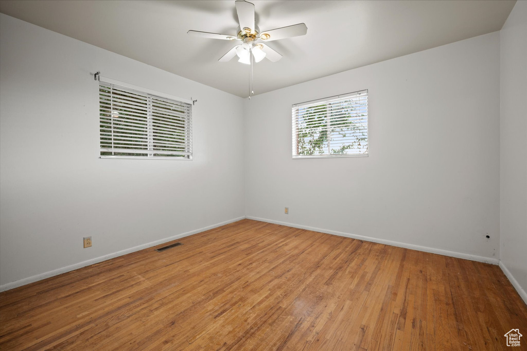 Unfurnished room featuring hardwood / wood-style floors and ceiling fan