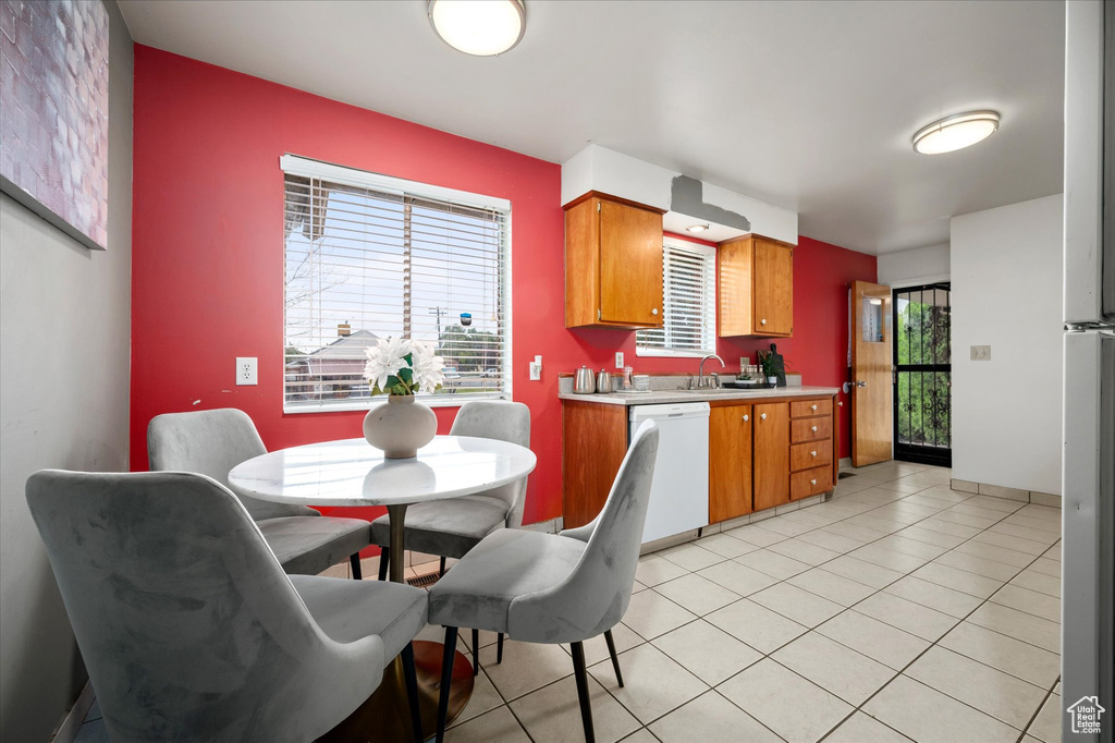 Kitchen with white dishwasher and light tile patterned floors