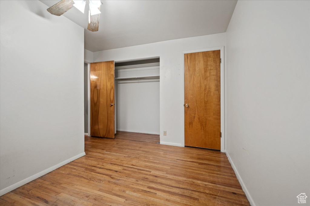 Unfurnished bedroom with light hardwood / wood-style floors, a closet, and ceiling fan