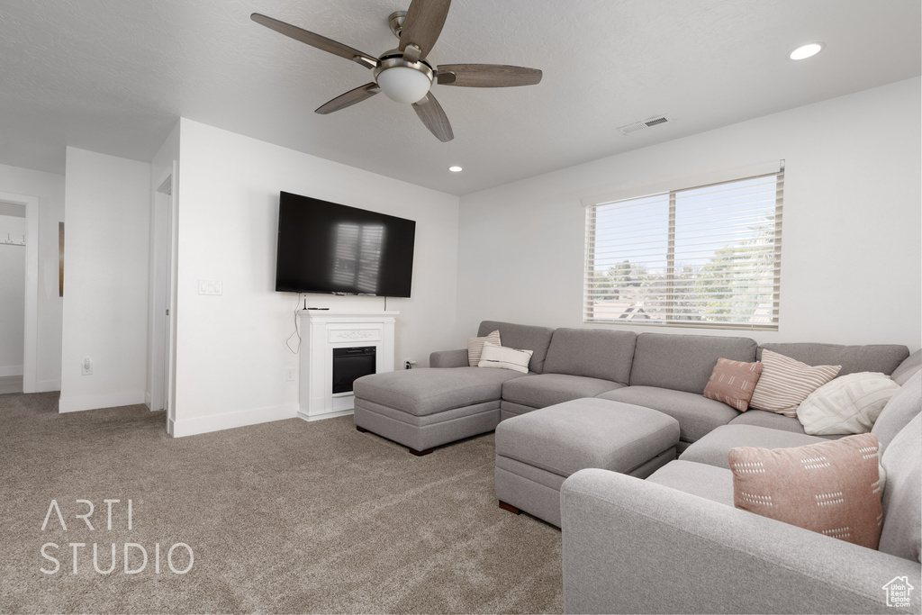Living room featuring light colored carpet and ceiling fan