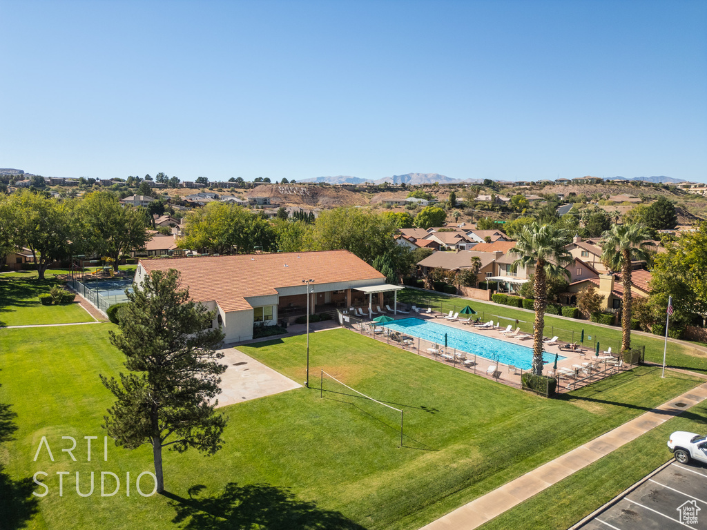 View of pool featuring a patio area, a mountain view, and a lawn