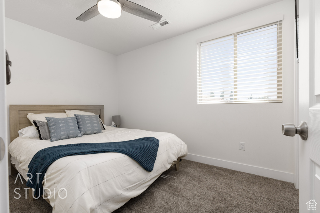 Bedroom featuring ceiling fan and carpet