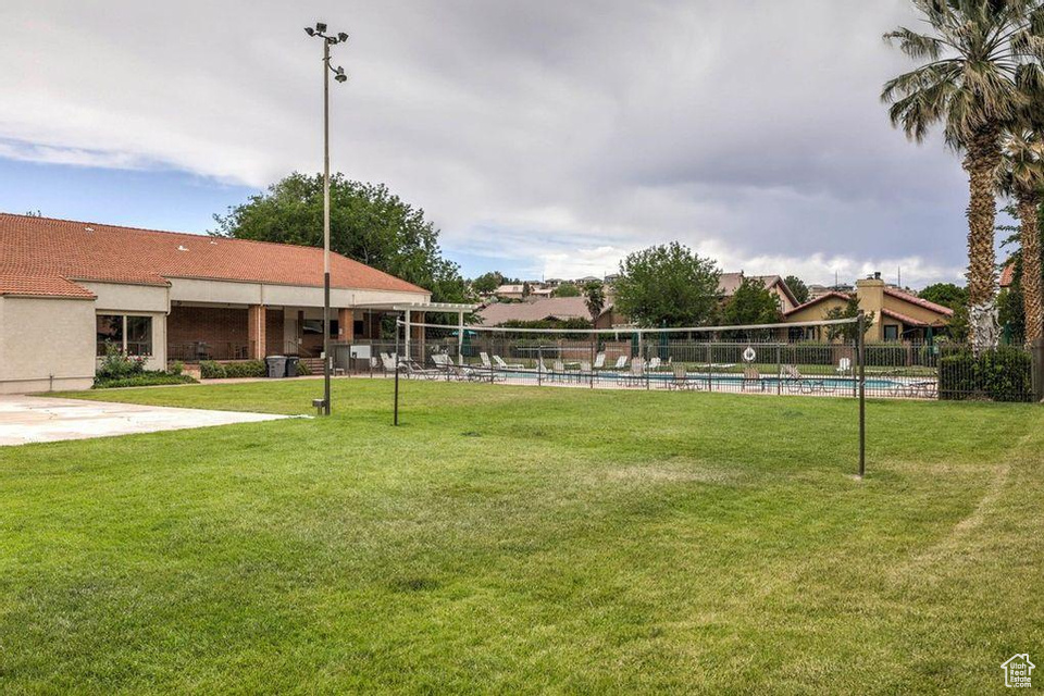 View of community with a yard and a swimming pool