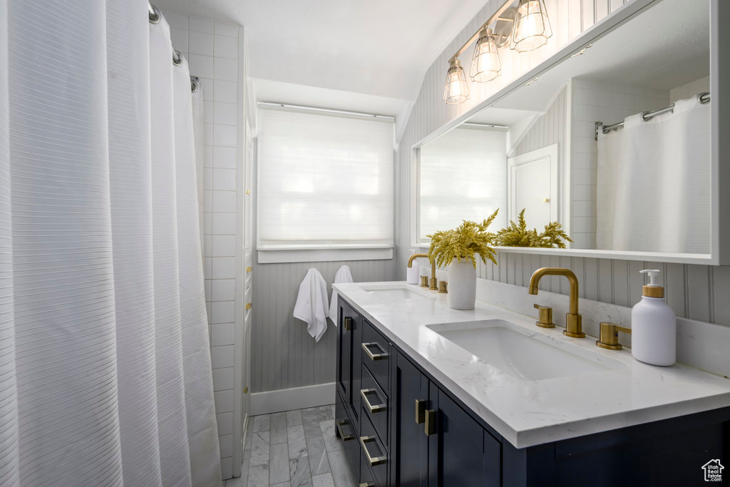 Bathroom featuring vanity and curtained shower