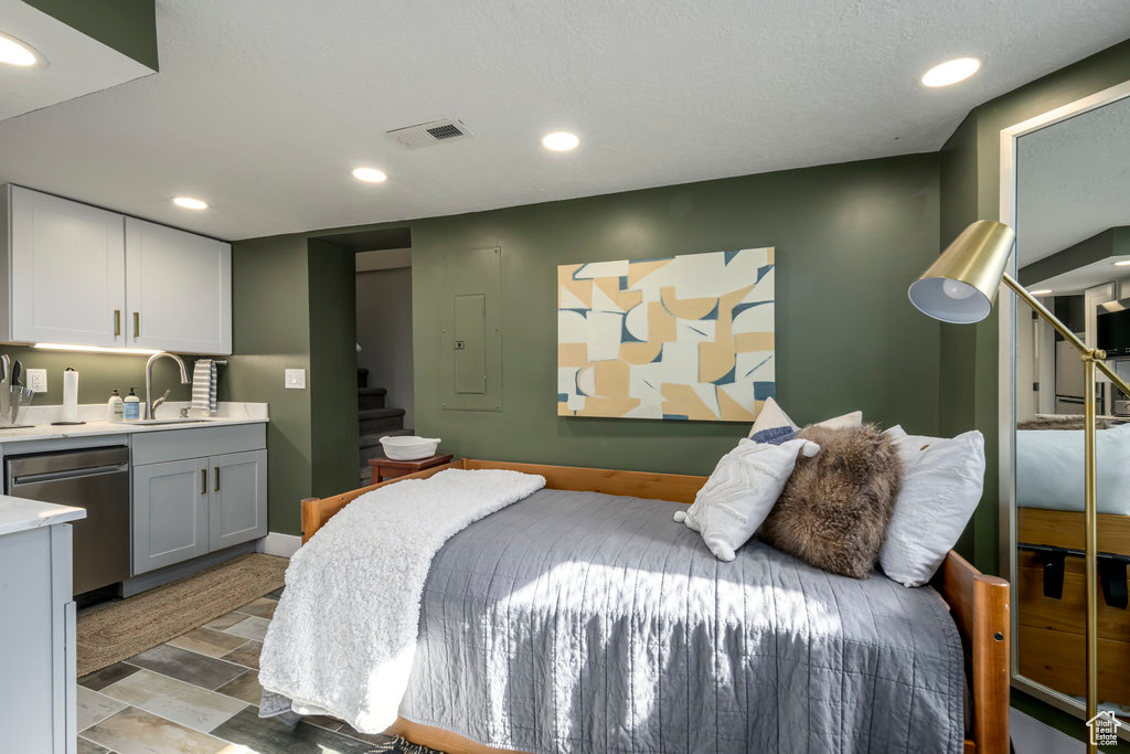 Bedroom featuring sink, a textured ceiling, and light hardwood / wood-style floors