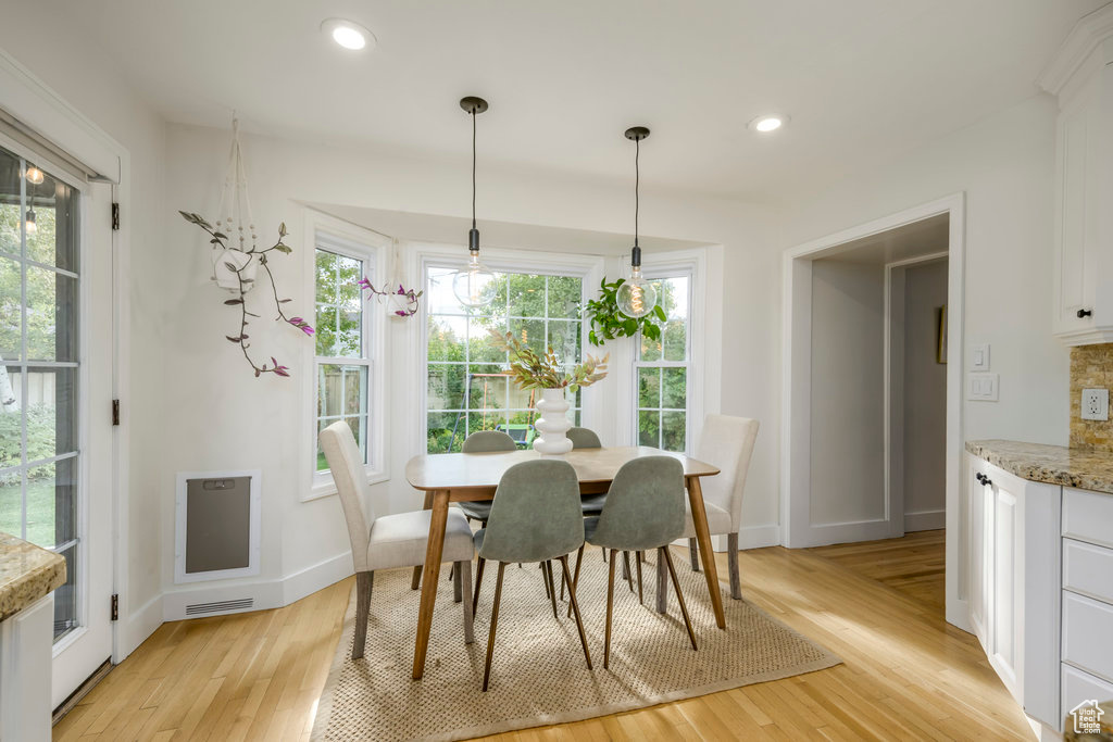 Dining space featuring light wood-type flooring and a healthy amount of sunlight