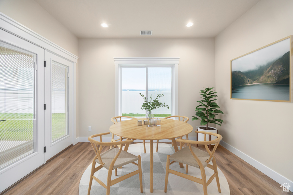 Dining space with light wood-style flooring, baseboards, and recessed lighting