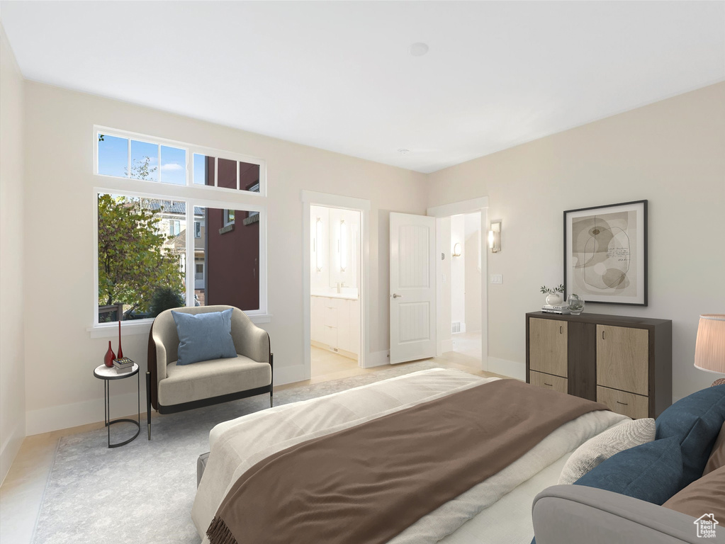 Bedroom featuring connected bathroom and baseboards