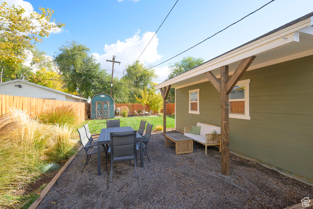 View of patio / terrace with an outdoor hangout area and a storage shed