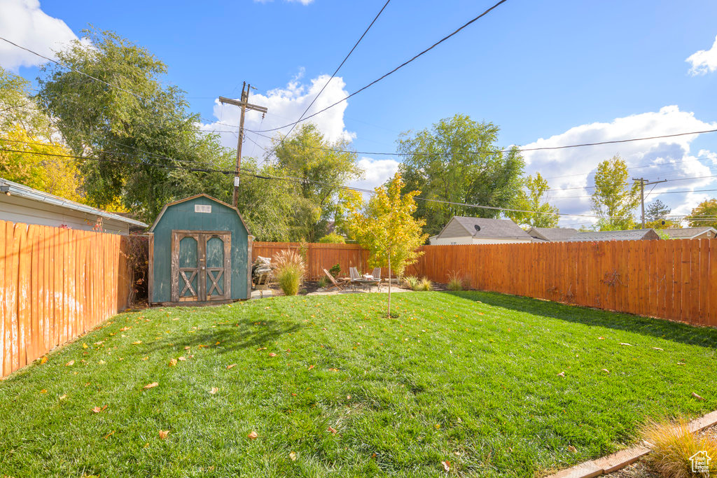 View of yard featuring a storage unit