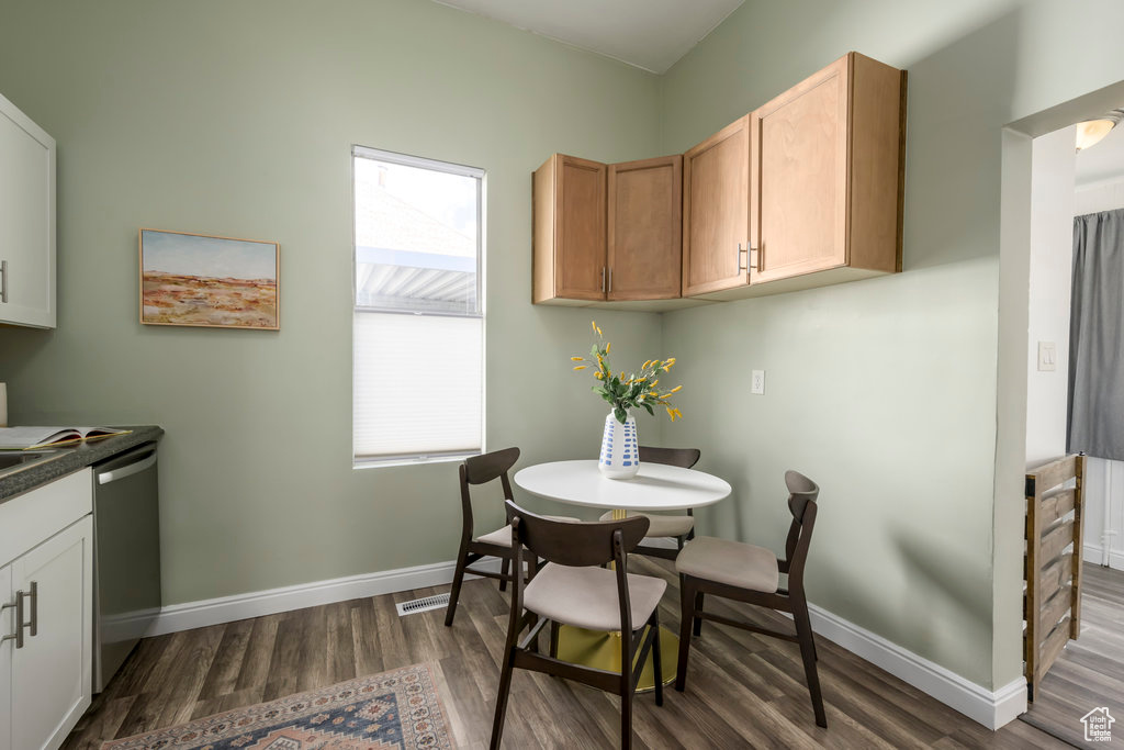 Dining area with dark hardwood / wood-style floors