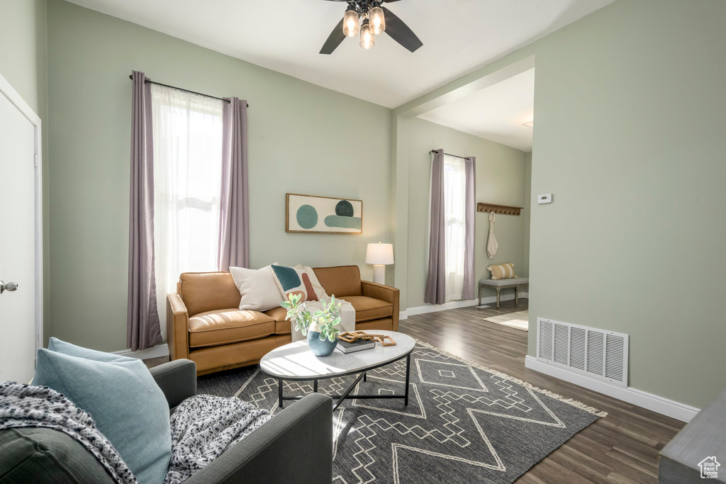 Living room featuring ceiling fan and dark hardwood / wood-style flooring