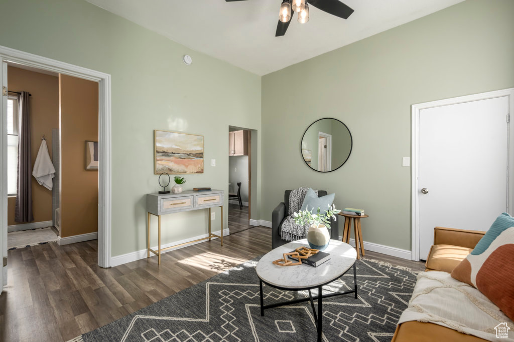 Living room with dark wood-type flooring and ceiling fan