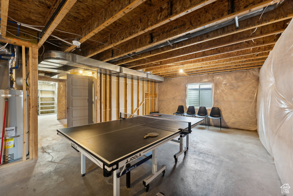 Playroom with gas water heater and concrete flooring