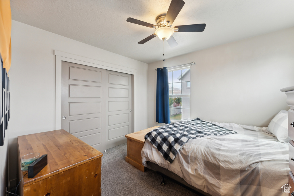 Bedroom with carpet flooring, a closet, and ceiling fan