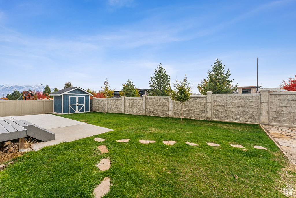 View of yard featuring a shed and a patio area