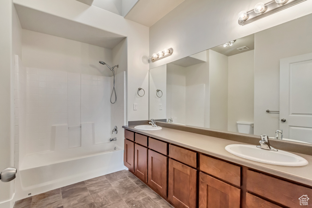 Full bathroom featuring vanity, shower / bathing tub combination, and toilet