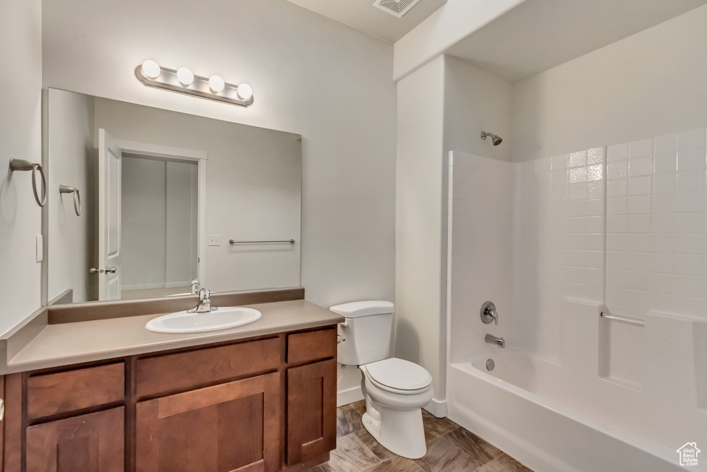 Full bathroom with vanity, toilet, and shower / bathtub combination