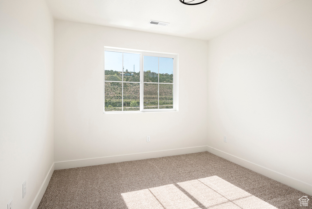 Empty room with light colored carpet