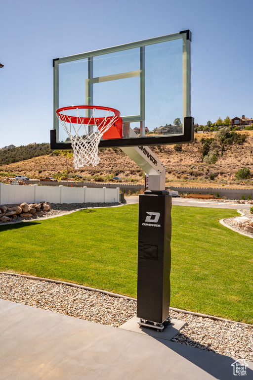 View of basketball court with a lawn