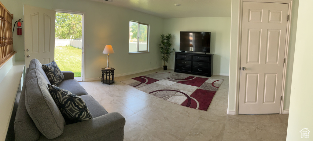 Living room featuring plenty of natural light and baseboards