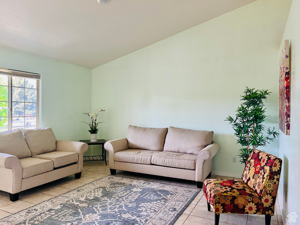 Living area with light tile patterned floors and baseboards