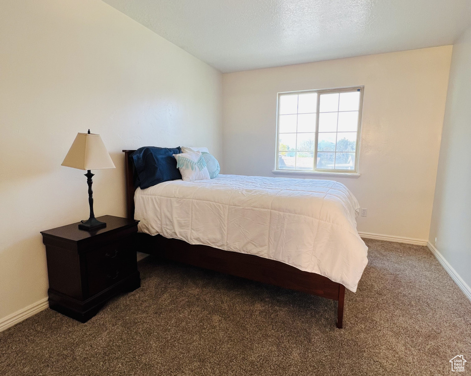 Carpeted bedroom with baseboards