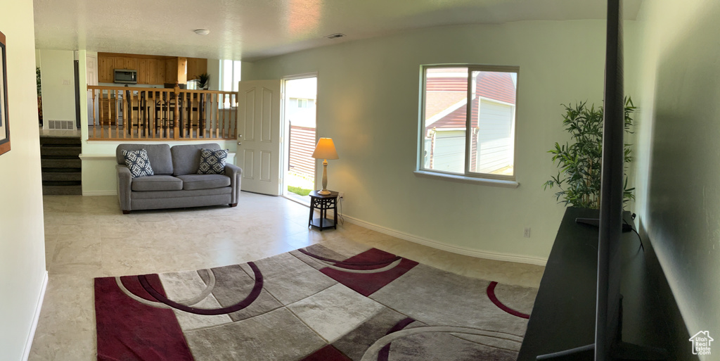 Living area featuring stairway and baseboards