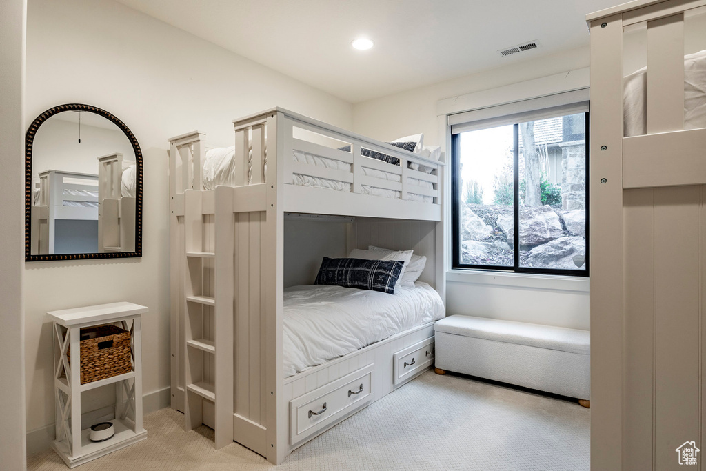 Bedroom featuring light colored carpet