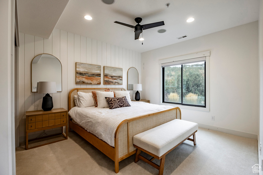 Carpeted bedroom featuring ceiling fan