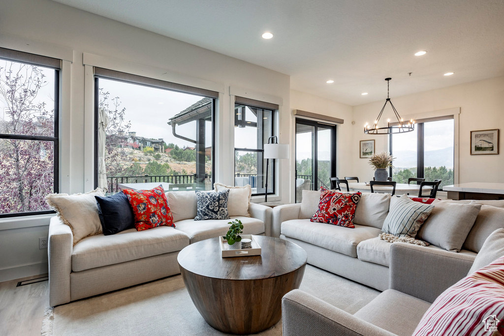 Living room with a chandelier and light wood-type flooring