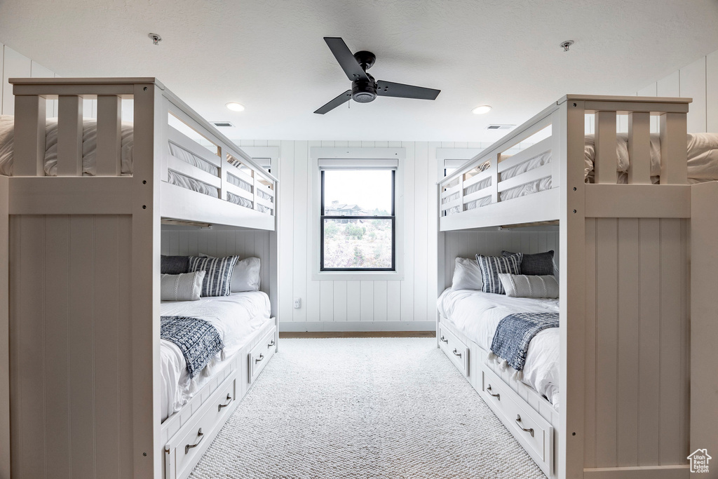 Bedroom with light colored carpet and ceiling fan