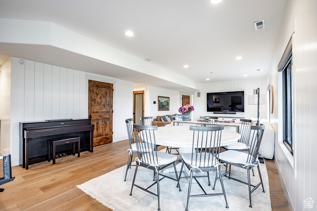 Dining area with plenty of natural light and light wood-type flooring