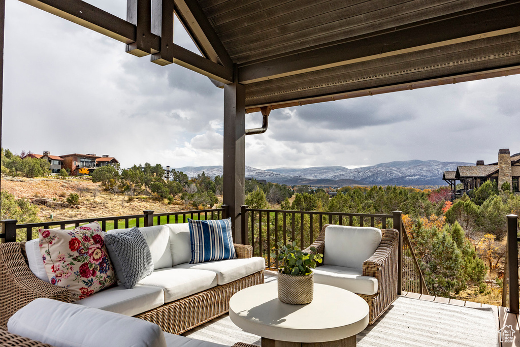 Wooden deck with an outdoor hangout area and a mountain view