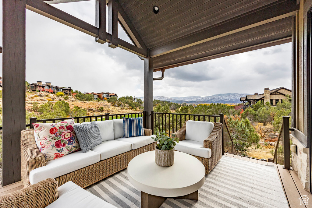 Wooden deck with a mountain view and outdoor lounge area