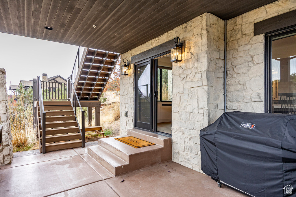 View of exterior entry with a patio area