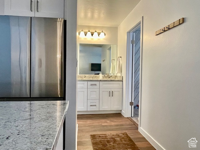 Bathroom with vanity and wood-type flooring